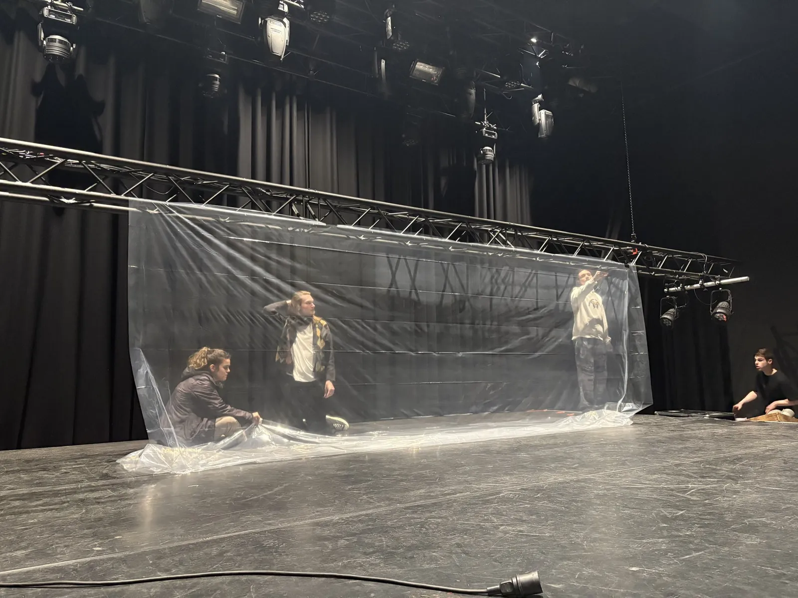 The transparent projection screen being set up on the stage of De Oosterpoort